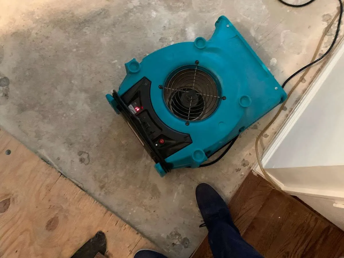 Air mover drying subfloor during Commercial Water Damage Restoration in Kenosha